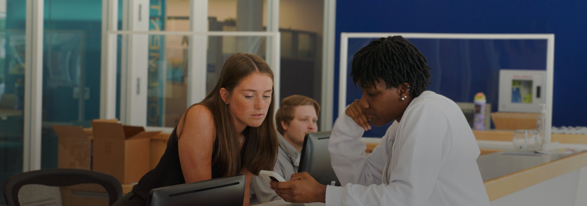 staff helping student in the hub